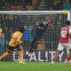 Wolverhampton Wanderers' goalkeeper Jose Sa, center, saves a shot during the Premier League soccer match between Wolverhampton Wanderers and Arsenal in Wolverhampton, England, Wednesday, Feb. 18, 2026. (AP Photo/Dave Shopland)