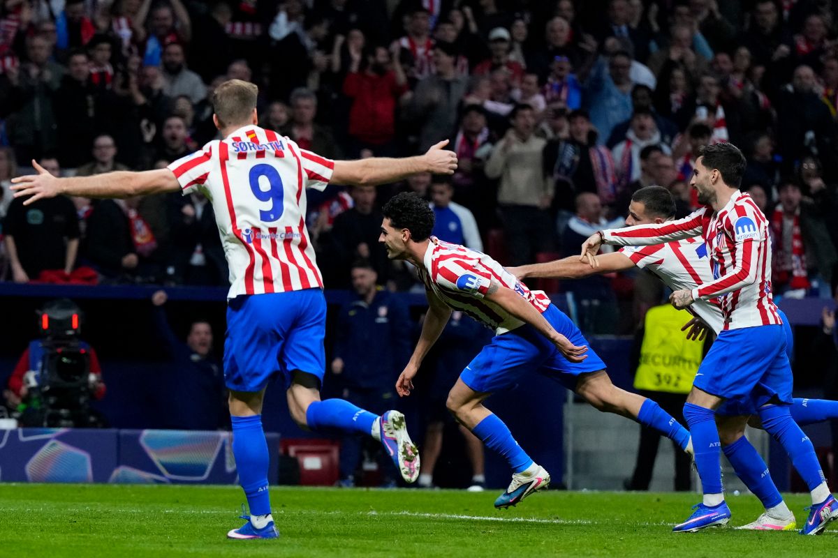 Atletico Madrid's Johnny Cardoso, center, celebrates after scoring his side's second goal during the Champions League play-off second leg soccer match between Atletico Madrid and Club Brugge, in Madrid, Spain, Tuesday, Feb. 24, 2026. (AP Photo/Manu Fernandez)