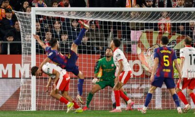 Girona's Hugo Rincon fights for the ball against Barcelona's Eric Garcia during a Spanish La Liga soccer match between Girona and Barcelona in Girona, Spain, Monday, Feb. 16, 2026. (AP Photo/Joan Monfort)