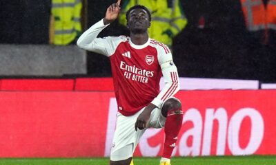 Arsenal's Bukayo Saka celebrates scoring their first goal during the Premier League soccer match between Wolverhampton Wanderers and Arsenal in Wolverhampton, England, Wednesday, Feb. 18, 2026. (Jacob King/PA via AP)