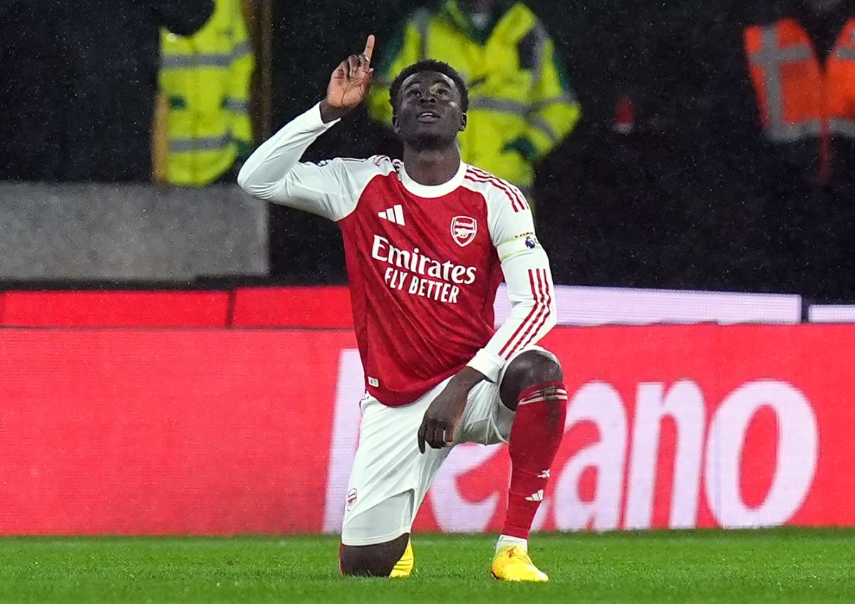 Arsenal's Bukayo Saka celebrates scoring their first goal during the Premier League soccer match between Wolverhampton Wanderers and Arsenal in Wolverhampton, England, Wednesday, Feb. 18, 2026. (Jacob King/PA via AP)
