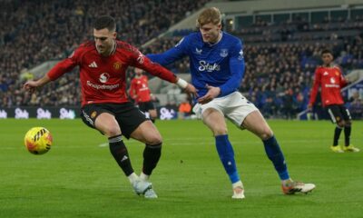 Manchester United's Diogo Dalot, left, and Everton's Jarrad Branthwaite fight for the ball during the Premier League soccer match between Manchester United and Everton in Liverpool, England, Monday, Feb. 23, 2026. (AP Photo/Ian Hodgson)