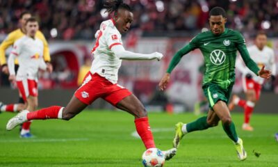 Leipzig's Yan Diomandé, left, and Wolfsburg's Jeanuel Belocian duiring the Bundesliga soccer match between RB Leipzig and VfL Wolfsburg in Leipzig, Germany, Sunday Feb. 15, 2026. (Jan Woitas/dpa via AP)