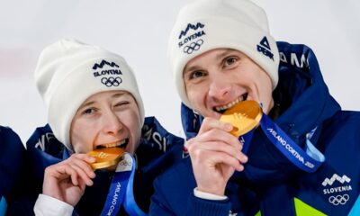 Siblings Nika Prevc, and Domen Prevc, of Slovenia, pose after winning the gold medal in the ski jumping mixed team competition at the 2026 Winter Olympics, in Predazzo, Italy, Tuesday, Feb. 10, 2026. (AP Photo/Matthias Schrader)