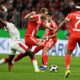 Bayern's Harry Kane, center, in action during the German Cup soccer match between Bayern Munich and RB Leipzig in Munich, Germany, Wednesday, Feb. 11, 2026. (Sven Hoppe/dpa via AP)