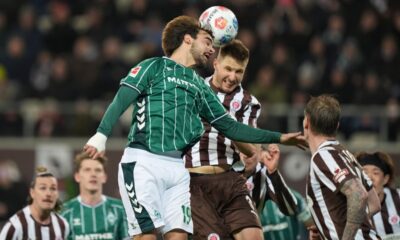 St. Pauli's Karol Mets, right, and Bremen's Jovan Milosevic in action during the Bundesliga soccer match between St. Pauli and Werder Bremen in Hamburg, Germany, Sunday Feb. 22, 2026. (Marcus Brandt/dpa via AP)