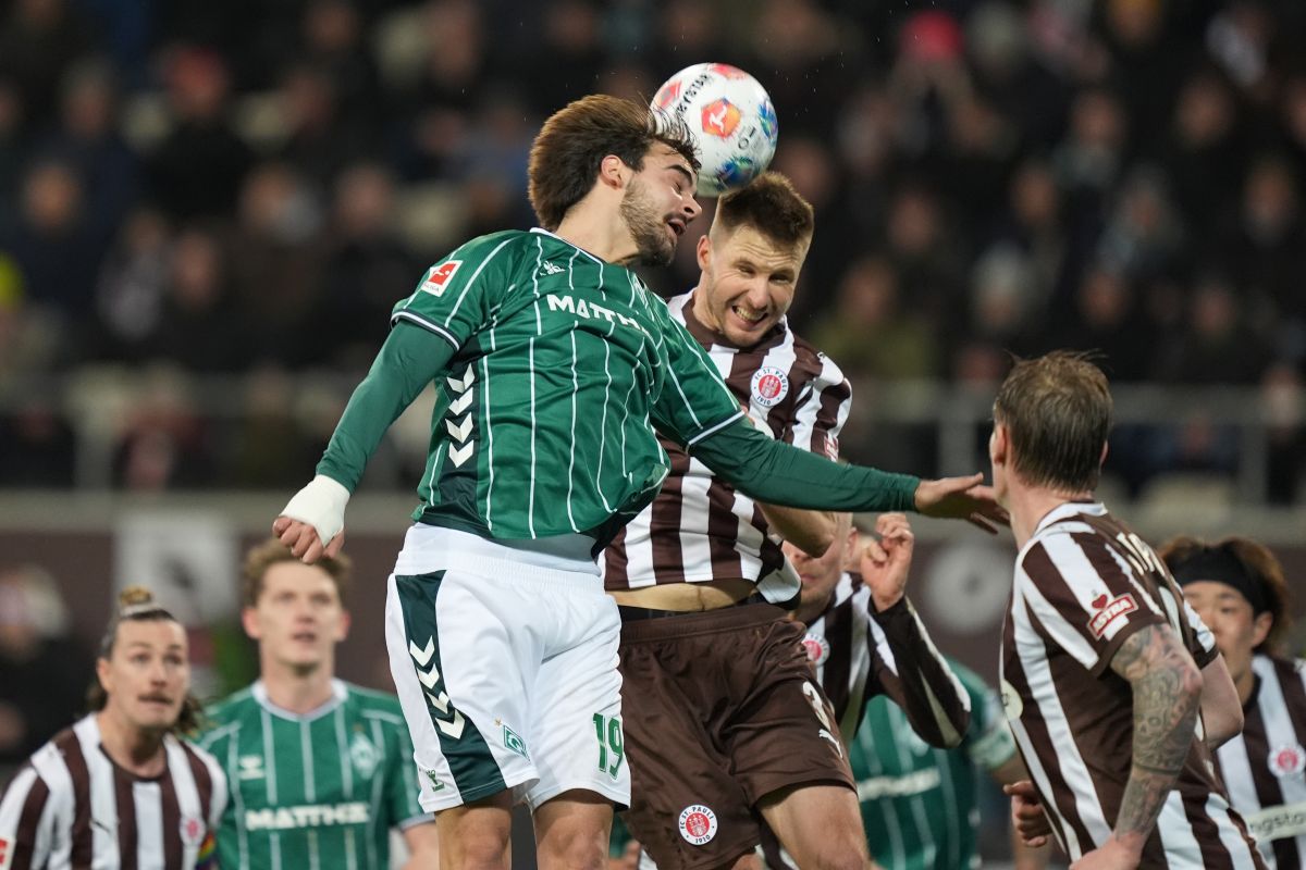 St. Pauli's Karol Mets, right, and Bremen's Jovan Milosevic in action during the Bundesliga soccer match between St. Pauli and Werder Bremen in Hamburg, Germany, Sunday Feb. 22, 2026. (Marcus Brandt/dpa via AP)