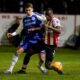 Macclesfield's Luis Lacey, left, and Brentford's Michael Kayode fight for the ball during the English FA cup fourth round soccer match between Macclesfield and Brentford in Macclesfield, England, Monday, Feb. 16, 2026. (AP Photo/Dave Thompson)