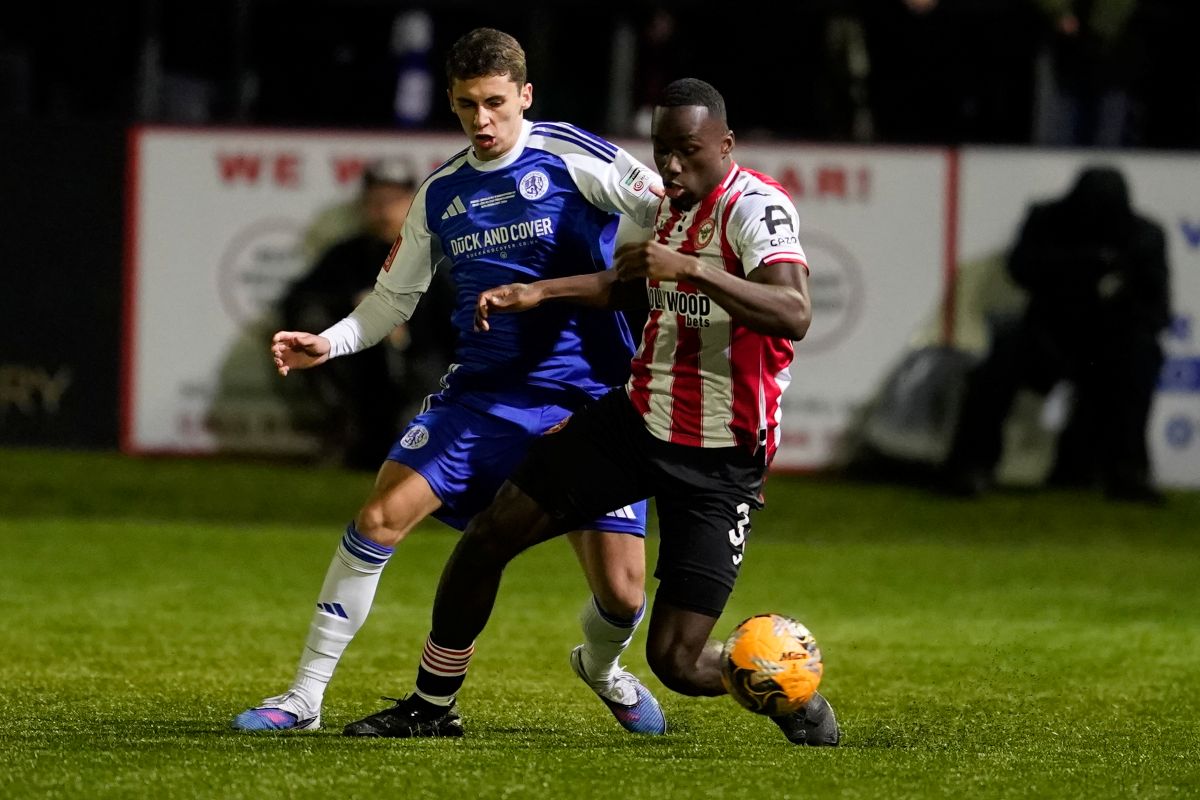 Macclesfield's Luis Lacey, left, and Brentford's Michael Kayode fight for the ball during the English FA cup fourth round soccer match between Macclesfield and Brentford in Macclesfield, England, Monday, Feb. 16, 2026. (AP Photo/Dave Thompson)
