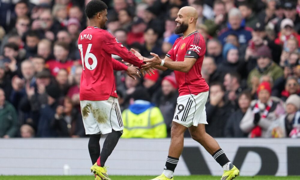 Manchester United's Amad Diallo, left, and Bryan Mbeumo react after a goal during the English Premier League soccer match between Manchester United and Tottenham in Manchester, England, Saturday, Feb. 7, 2026. (AP Photo/Jon Super)