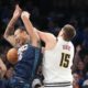 Oklahoma City Thunder forward Jaylin Williams (6) falls into Denver Nuggets center Nikola Jokic (15) as he goes after a rebound during the second half of an NBA basketball game, Friday, Feb. 27, 2026, in Oklahoma City. (AP Photo/Kyle Phillips)