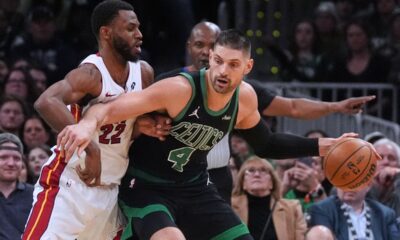 Miami Heat forward Andrew Wiggins (22) tries to stop Boston Celtics center Nikola Vucevic (4) during the second half of an NBA basketball game, Friday, Feb. 6, 2026, in Boston. (AP Photo/Charles Krupa)