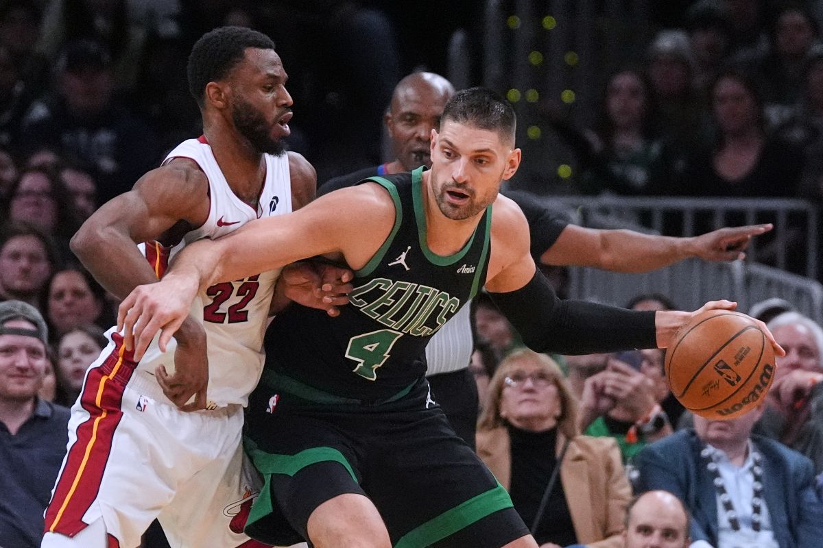 Miami Heat forward Andrew Wiggins (22) tries to stop Boston Celtics center Nikola Vucevic (4) during the second half of an NBA basketball game, Friday, Feb. 6, 2026, in Boston. (AP Photo/Charles Krupa)