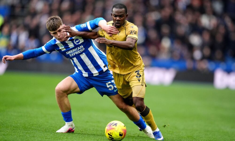 Brighton and Hove Albion's Harry Howell, left, battles for the ball with Crystal Palace's Tyrick Mitchell during their English Premier League soccer match in Brighton, England, Sunday, Feb. 8, 2026. (Adam Davy/PA via AP)