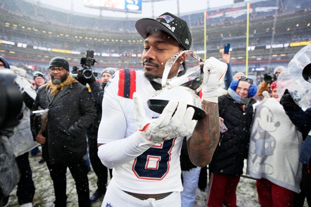 ***New England Patriots wide receiver Stefon Diggs celebrates with the trophy after the AFC Championship NFL football game between the Denver Broncos and the New England Patriots, Sunday, Jan. 25, 2026, in Denver. (AP Photo/John Locher)