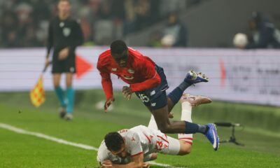 Red Star's Milos Veljkovic, bottom, challenges for the ball with Lille's Soriba Diaoune during the Europa League round of 16 soccer match between Lille and Red Star, in Lille, northern France, Thursday, Feb. 19, 2026.(AP Photo/Jean-Francois Badias)