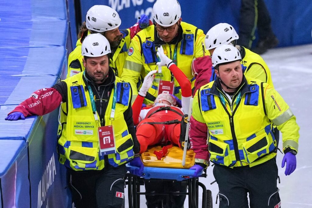 Kamila Sellier of Poland is helped after falling during a short track speed skating women's 1500 meters quarterfinal at the 2026 Winter Olympics, in Milan, Italy, Friday, Feb. 20, 2026. (AP Photo/Stephanie Scarbrough)