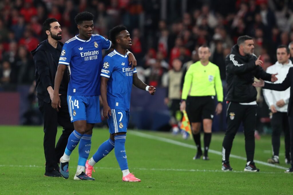Real Madrid's Vinicius Junior argues with Benfica players after scoring the opening goal during a Champions League playoff soccer match between SL Benfica and Real Madrid in Lisbon, Portugal, Tuesday, Feb. 17, 2026. (AP Photo/Pedro Rocha)