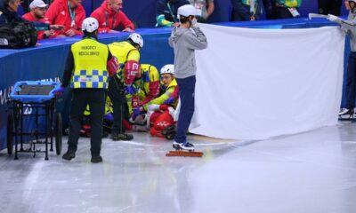 Kamila Sellier of Poland is helped after falling during a short track speed skating women's 1500 meters quarterfinal at the 2026 Winter Olympics, in Milan, Italy, Friday, Feb. 20, 2026. (AP Photo/Stephanie Scarbrough)