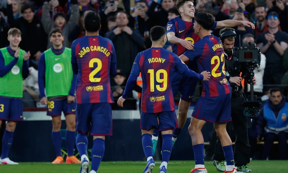 Barcelona's Marc Bernal, right, is congratulated after scoring his side's 3rd goal during the Spanish La Liga soccer match between Barcelona and Mallorca in Barcelona, Spain, Saturday, Feb. 7, 2026. (AP Photo/Joan Monfort)