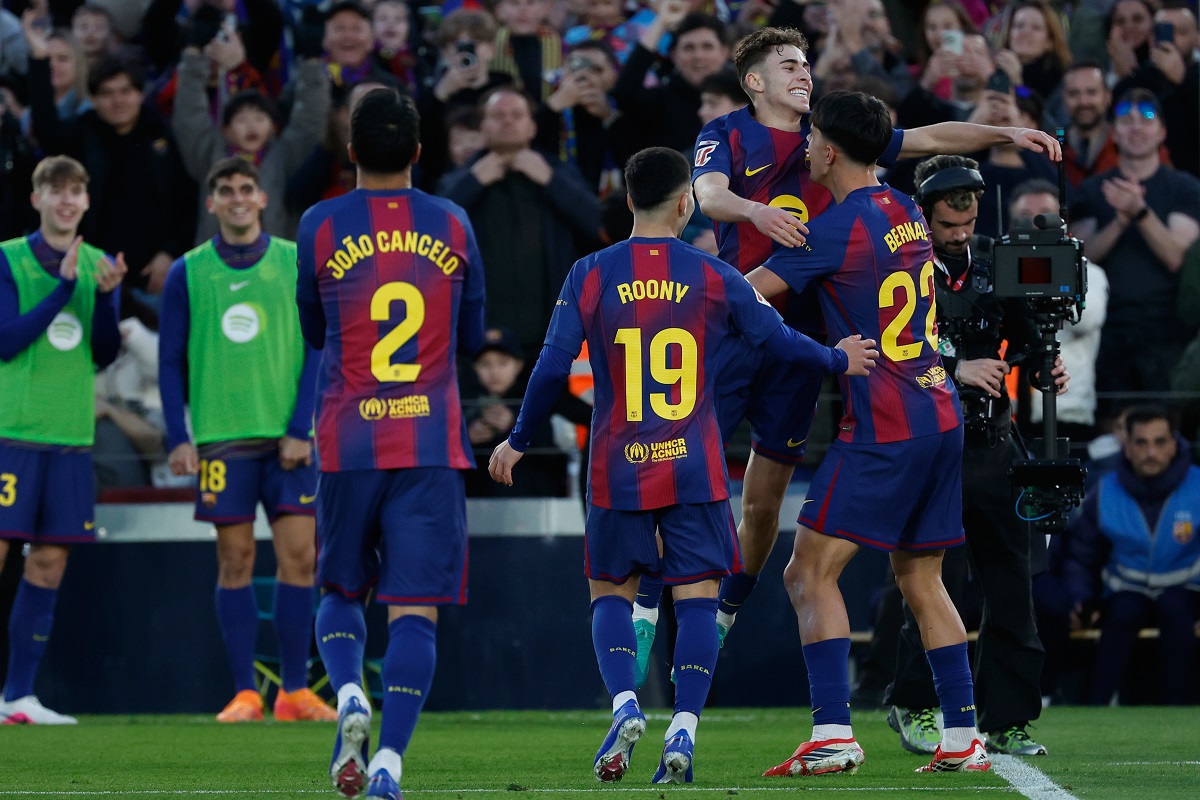Barcelona's Marc Bernal, right, is congratulated after scoring his side's 3rd goal during the Spanish La Liga soccer match between Barcelona and Mallorca in Barcelona, Spain, Saturday, Feb. 7, 2026. (AP Photo/Joan Monfort)