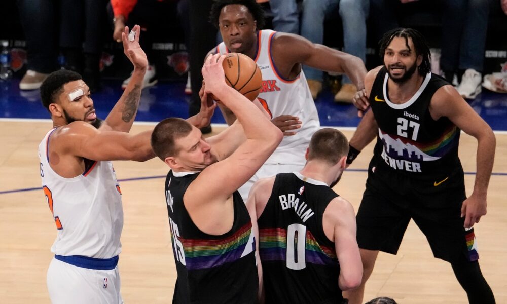 New York Knicks center Karl-Anthony Towns (32) attempts to steal the ball from Denver Nuggets center Nikola Jokic (15) during the second half of an NBA basketball game, Wednesday, Feb. 4, 2026, in New York. (AP Photo/Yuki Iwamura)