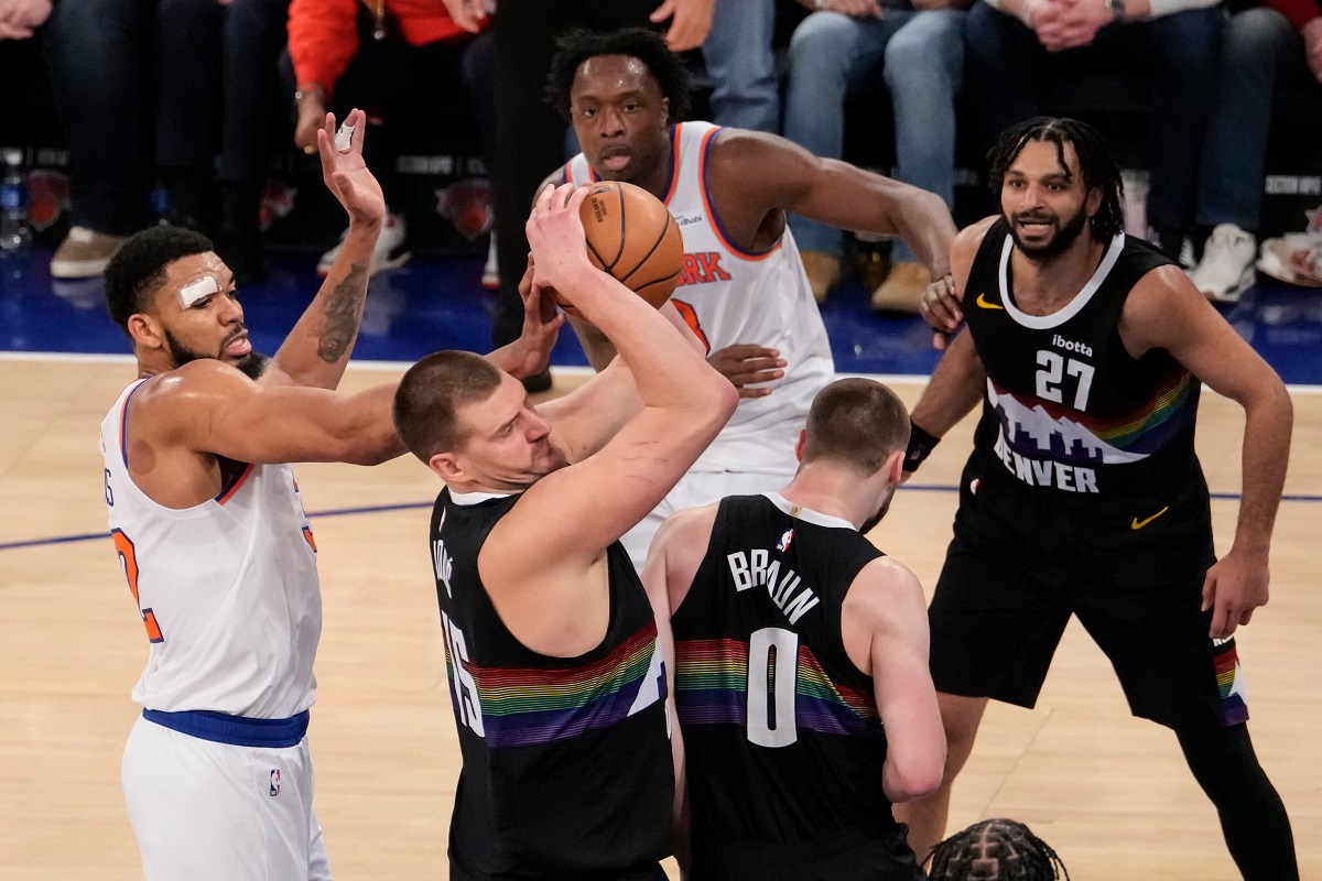 New York Knicks center Karl-Anthony Towns (32) attempts to steal the ball from Denver Nuggets center Nikola Jokic (15) during the second half of an NBA basketball game, Wednesday, Feb. 4, 2026, in New York. (AP Photo/Yuki Iwamura)