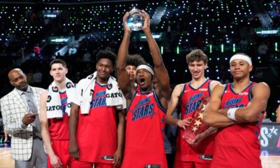 Members of Team Vince hold up their trophies after they defeated Team Melo in a final in NBA basketball's Rising Stars event Friday, Feb. 13, 2026, in Inglewood, Calif. (AP Photo/Mark J. Terrill)