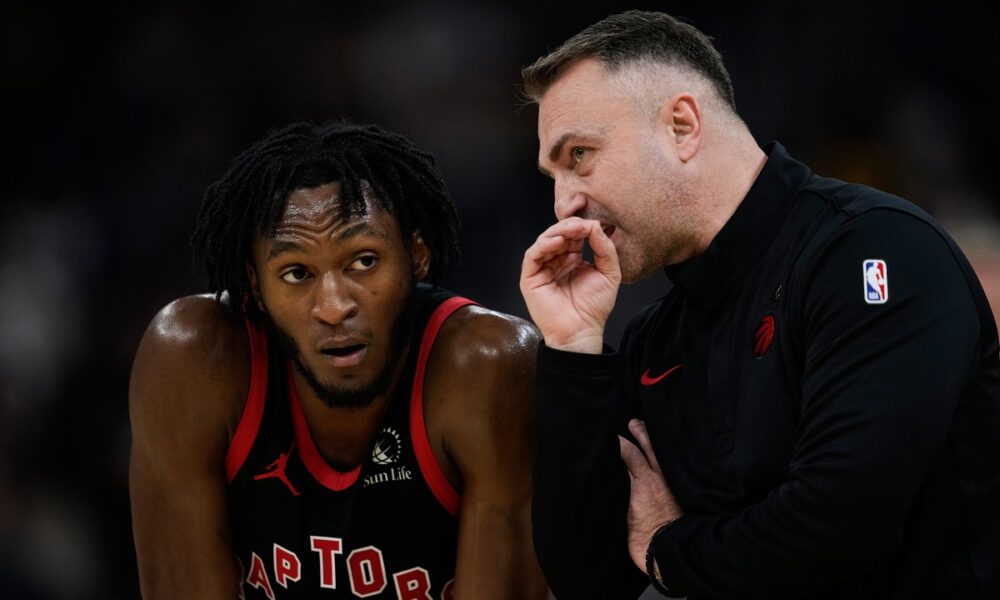 Toronto Raptors head coach Darko Rajakovic, right, speaks to guard Immanuel Quickley (5) during the second half of an NBA basketball game against the Golden State Warriors, Tuesday, Jan. 20, 2026, in San Francisco. (AP Photo/Godofredo A. Vásquez)