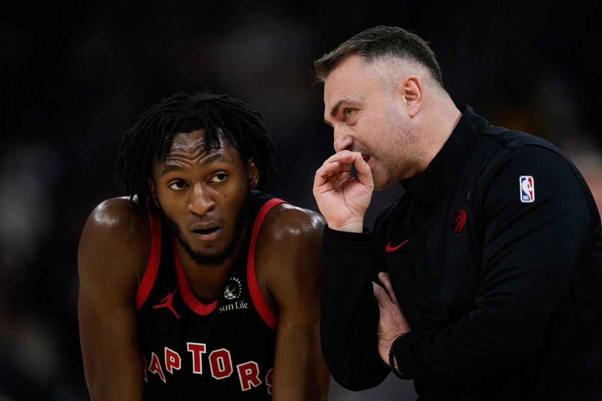 Toronto Raptors head coach Darko Rajakovic, right, speaks to guard Immanuel Quickley (5) during the second half of an NBA basketball game against the Golden State Warriors, Tuesday, Jan. 20, 2026, in San Francisco. (AP Photo/Godofredo A. Vásquez)