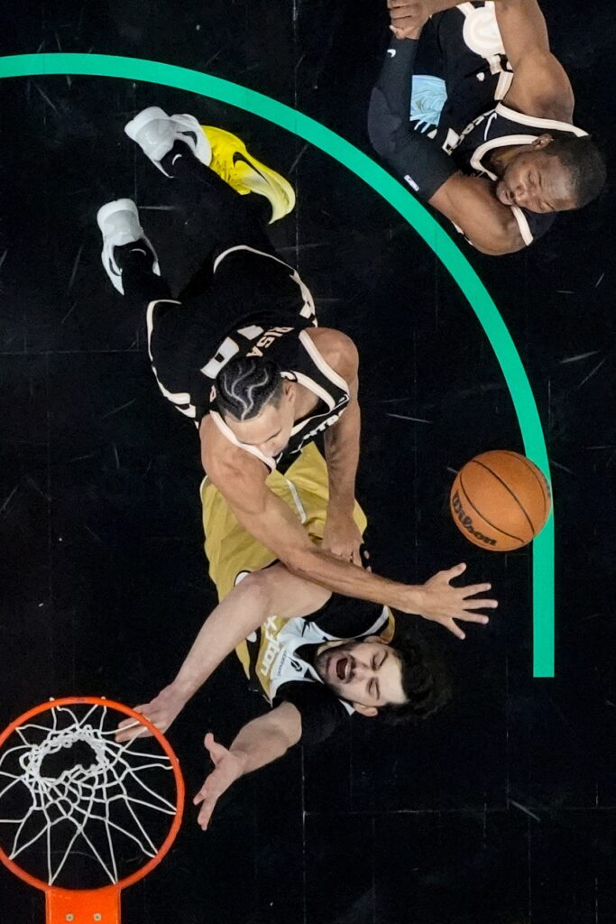 Washington Wizards forward Tristan Vukcevic (00) shoots against Atlanta Hawks forward Zaccharie Risacher (10) during the first half of an NBA basketball game, Thursday, Feb. 26, 2026, in Atlanta. (AP Photo/Mike Stewart)