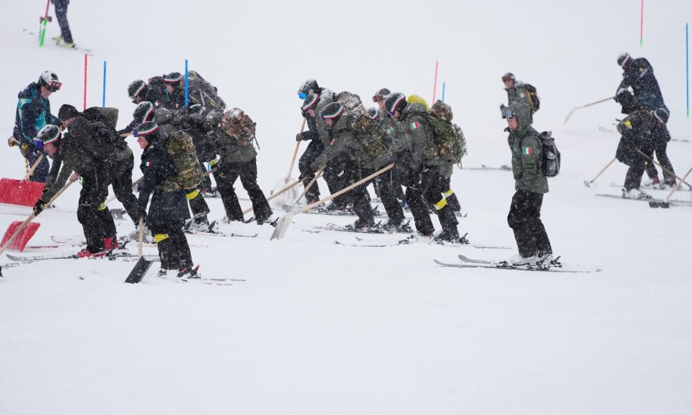 Workers clear the course ahead of an alpine ski, men's slalom race, at the 2026 Winter Olympics, in Bormio, Italy, Monday, Feb. 16, 2026. (AP Photo/John Locher)