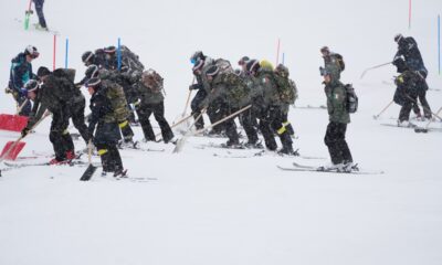 Workers clear the course ahead of an alpine ski, men's slalom race, at the 2026 Winter Olympics, in Bormio, Italy, Monday, Feb. 16, 2026. (AP Photo/John Locher)