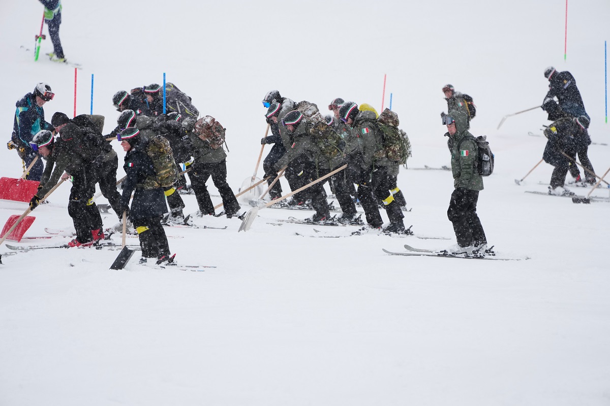 Workers clear the course ahead of an alpine ski, men's slalom race, at the 2026 Winter Olympics, in Bormio, Italy, Monday, Feb. 16, 2026. (AP Photo/John Locher)