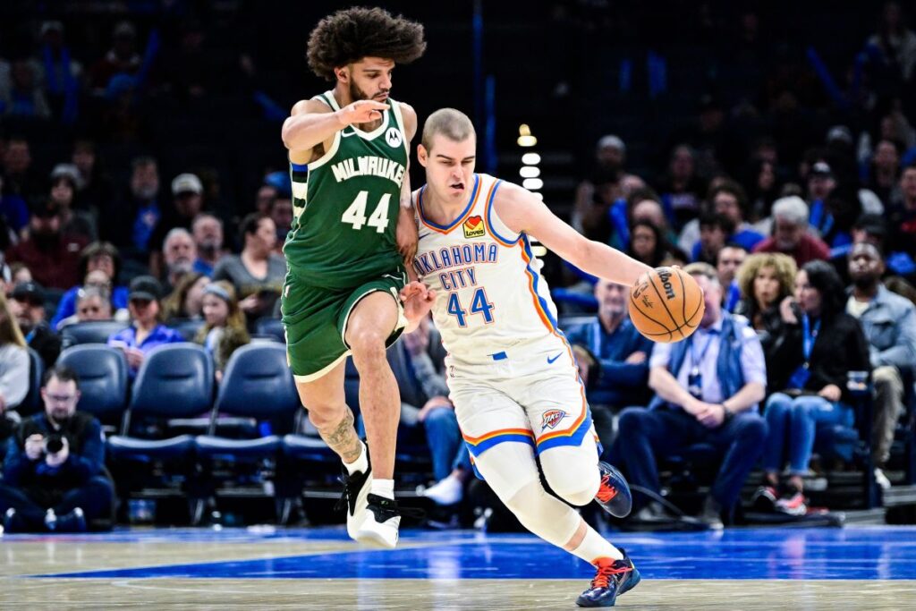 Oklahoma City Thunder guard Nikola Topić (44), right, drives against Milwaukee Bucks guard Andre Jackson Jr. (44) during the second half of an NBA basketball game, Thursday, Feb. 12, 2026, in Oklahoma City. (AP Photo/Gerald Leong)