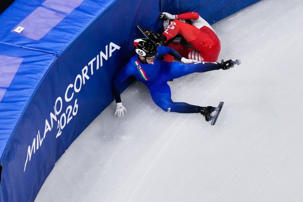 Kamila Sellier of Poland, top, and Arianna Fontana of Italy fall during a short track speed skating women's 1500 meters quarterfinal at the 2026 Winter Olympics, in Milan, Italy, Friday, Feb. 20, 2026. (AP Photo/Bernat Armangue)