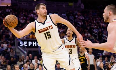 Denver Nuggets center Nikola Jokic keeps the ball in play during the first half of an NBA basketball game against the Golden State Warriors, Sunday, Feb. 22, 2026, in San Francisco. (AP Photo/Kelley L Cox)