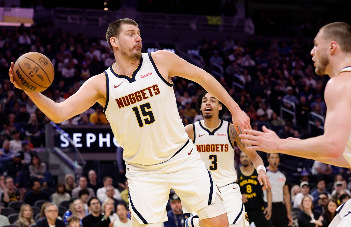 Denver Nuggets center Nikola Jokic keeps the ball in play during the first half of an NBA basketball game against the Golden State Warriors, Sunday, Feb. 22, 2026, in San Francisco. (AP Photo/Kelley L Cox)
