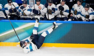 Finland's Roope Hintz, bottom, falls during a preliminary round match of men's ice hockey between Slovakia and Finland at the 2026 Winter Olympics, in Milan, Italy, Wednesday, Feb. 11, 2026. (AP Photo/Petr David Josek)