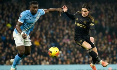 Manchester City's Marc Guehi, left, and Fulham's Harry Wilson challenge for the ball during the English Premier League soccer match between Manchester City and Fulham in Manchester, England, Wednesday, Feb. 11, 2026. (AP Photo/Dave Thompson)