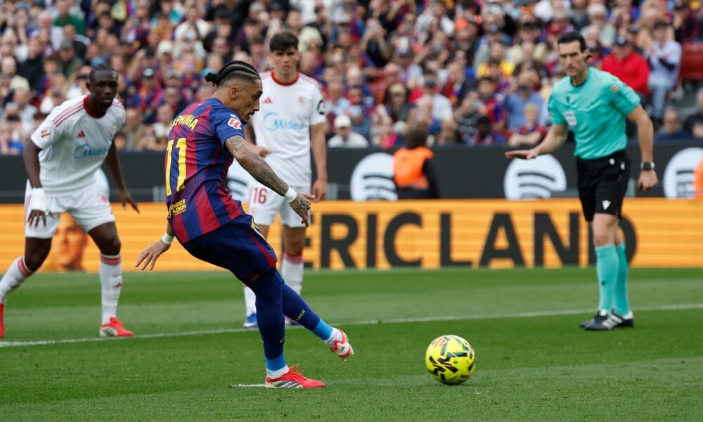 Barcelona's Raphinha scores on a penalty kick during the Spanish La Liga soccer match between Barcelona and Sevilla in Barcelona, Spain, Sunday, March 15, 2026. (AP Photo/Joan Monfort)