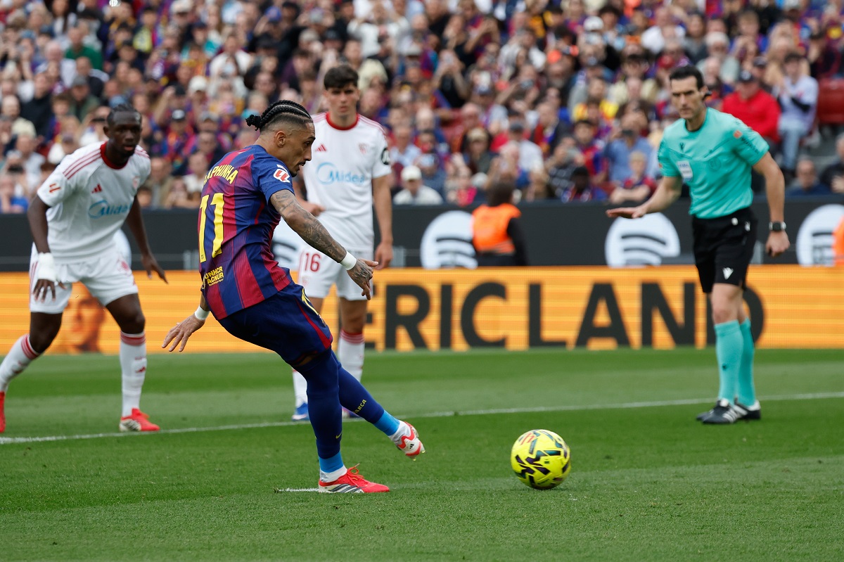 Barcelona's Raphinha scores on a penalty kick during the Spanish La Liga soccer match between Barcelona and Sevilla in Barcelona, Spain, Sunday, March 15, 2026. (AP Photo/Joan Monfort)