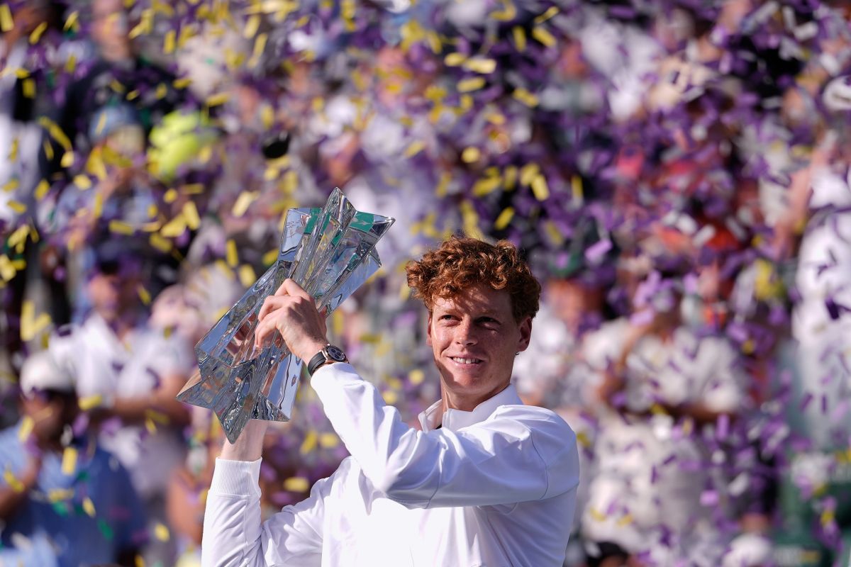 Jannik Sinner, of Italy, holds the winner's trophy after defeating Daniil Medvedev, of Russia, right, during a final match at the BNP Paribas Open tennis tournament, Sunday, March 15, 2026, in Indian Wells, Calif. (AP Photo/Mark J. Terrill)