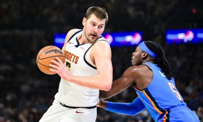 Denver Nuggets center Nikola Jokić, left, drives against Oklahoma City Thunder guard Luguentz Dort (5) during the first half of an NBA basketball game, Monday, Mar. 9, 2026, in Oklahoma City. (AP Photo/Gerald Leong)