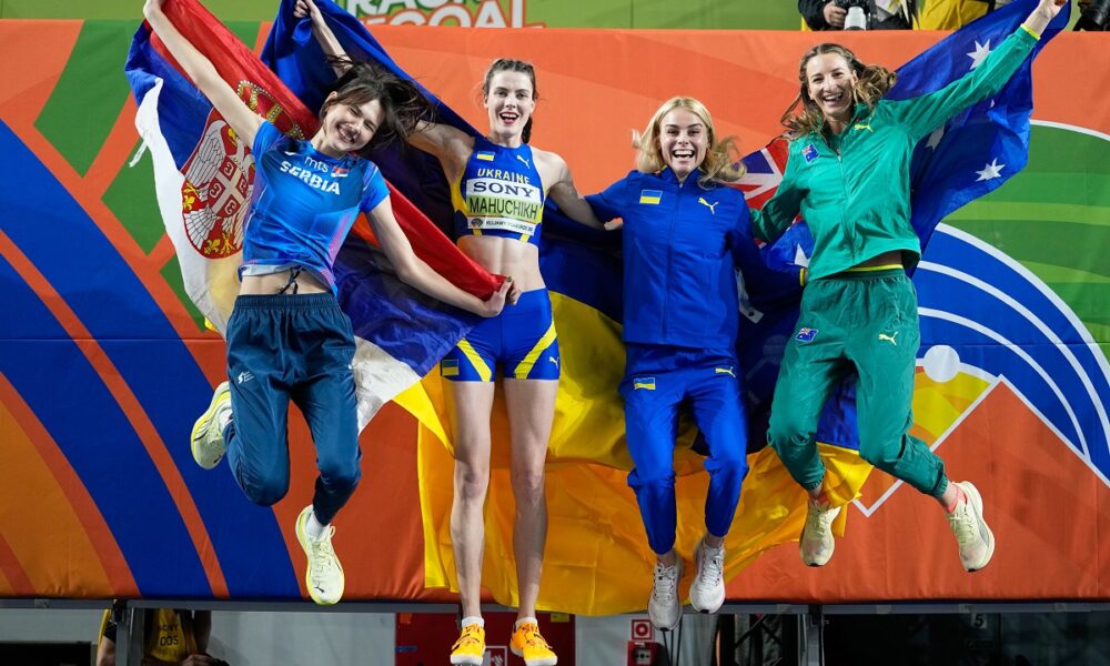 Angelina Topic, of Serbia, Yaroslava Mahuchikh, of Ukraine, Yuliia Levchenko, of Ukraine, and Nicola Olyslagers, of Australia, from left, jump for a winners photo after the women's high jump final at the World Athletics Indoor Championships in Torun, Poland, Friday, March 20, 2026. (AP Photo/Matthias Schrader)