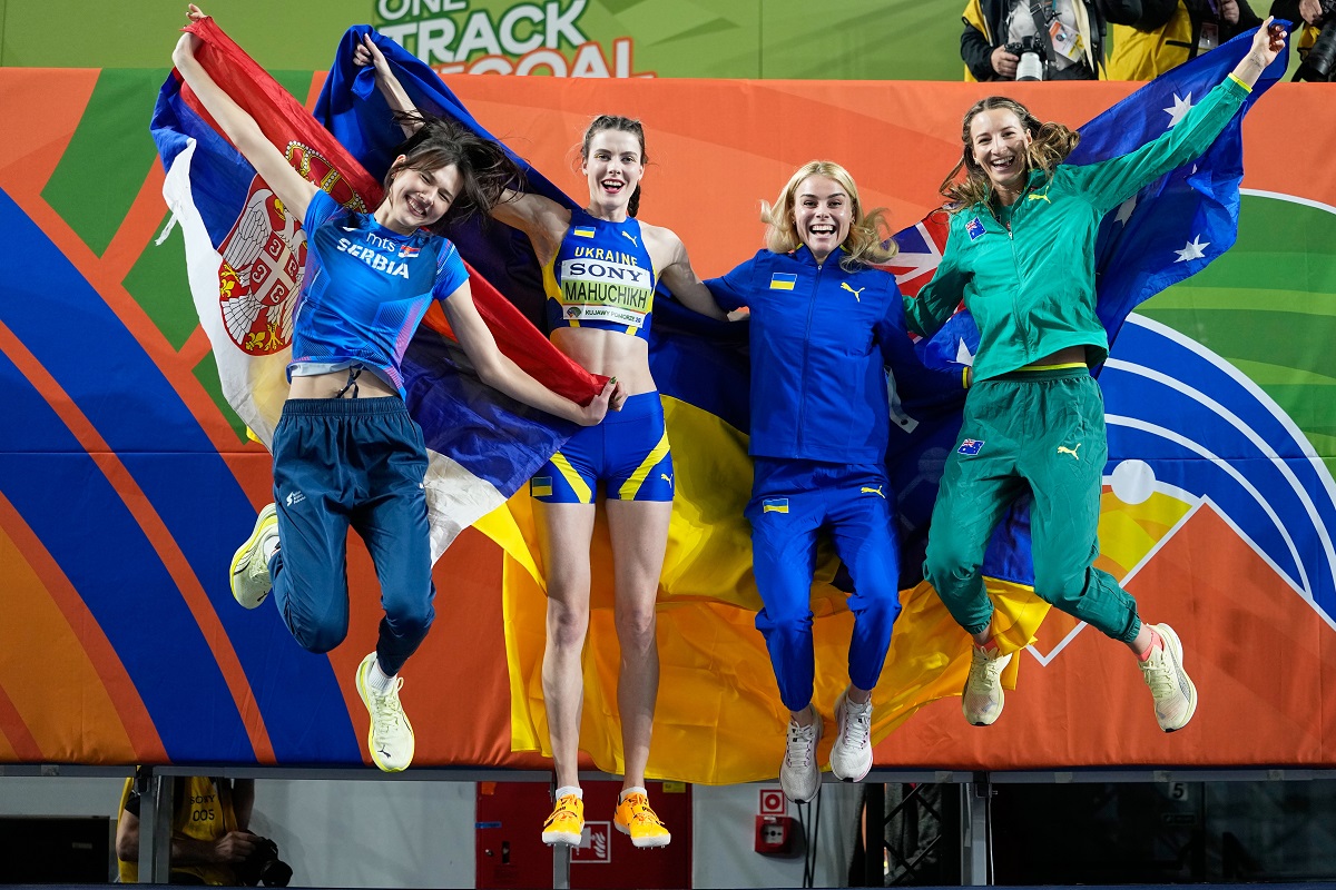 Angelina Topic, of Serbia, Yaroslava Mahuchikh, of Ukraine, Yuliia Levchenko, of Ukraine, and Nicola Olyslagers, of Australia, from left, jump for a winners photo after the women's high jump final at the World Athletics Indoor Championships in Torun, Poland, Friday, March 20, 2026. (AP Photo/Matthias Schrader)