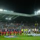 Barcelona, left, and Newcastle line up before the Champions League round of 16 first leg soccer match between Newcastle United and Barcelona in Newcastle , England, Tuesday, March 10, 2026. (AP Photo/Jon Super)