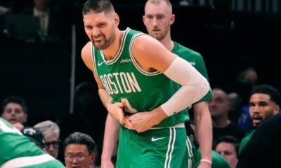 Boston Celtics center Nikola Vucevic grabs a finger after an apparent injury during the first half of an NBA basketball game against the Dallas Mavericks, Friday, March 6, 2026, in Boston. (AP Photo/Charles Krupa)