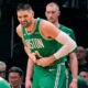Boston Celtics center Nikola Vucevic grabs a finger after an apparent injury during the first half of an NBA basketball game against the Dallas Mavericks, Friday, March 6, 2026, in Boston. (AP Photo/Charles Krupa)