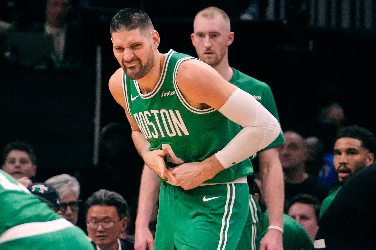 Boston Celtics center Nikola Vucevic grabs a finger after an apparent injury during the first half of an NBA basketball game against the Dallas Mavericks, Friday, March 6, 2026, in Boston. (AP Photo/Charles Krupa)